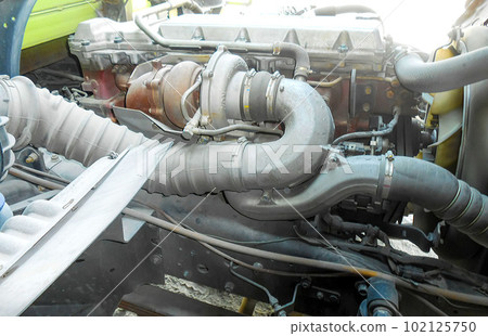Diesel truck engine or truck engine with copy space for text. Metallic background of the internal diesel truck engine or car engine. Diesel truck engine or truck engine with copy space for text. Metallic background of the internal diesel truck engine or car engine. 102125750