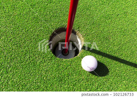 Golf course green and hole in good weather 102126733