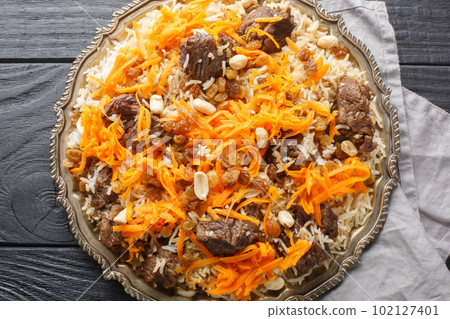 Kabuli pulao luxurious pilaf Afghan national dish closeup on the plate. Horizontal top view 102127401