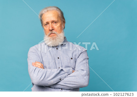 Portrait angry old man white bearded pensioner unhappy mad crazy conflict disagreement over blue color copy space background - negative human emotions face expression feelings 102127623