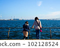A pair of girls looking at the sea from the sunny Yokohama Rinko Park 102128524