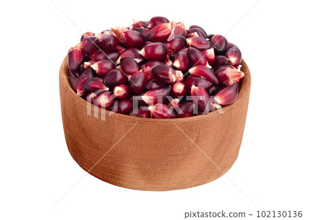 Purple corn seeds in wooden bowl isolated on white background with full depth of field Purple corn seeds in wooden bowl isolated on white background with full depth of field 102130136