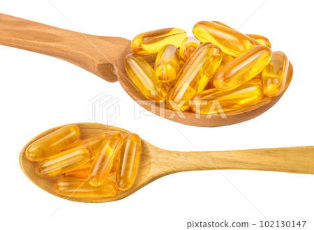 Fish oil capsules in wooden spoon isolated on white background with full depth of field. Top view. Flat lay Fish oil capsules in wooden spoon isolated on white background with full depth of field. Top view. Flat lay 102130147