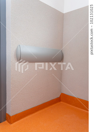 Gray wall bumper mounted on the corridor inside the building. Gray wall bumper mounted on the corridor inside the building. 102131025