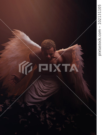 Young strong angel with white wings from heaven. Angel with muscular body. Sensual man Young strong angel with white wings from heaven. Angel with muscular body. Sensual man 102131105
