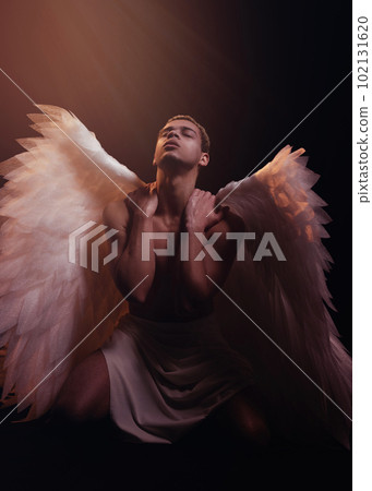 Young strong angel with white wings from heaven. Angel with muscular body. Sensual man Young strong angel with white wings from heaven. Angel with muscular body. Sensual man 102131620
