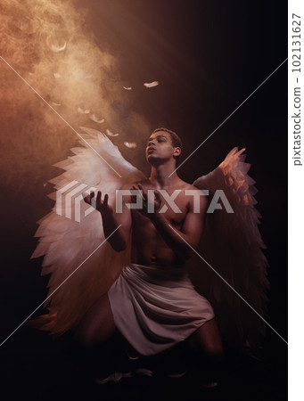 Young strong angel with white wings from heaven. Angel with muscular body. Sensual man Young strong angel with white wings from heaven. Angel with muscular body. Sensual man 102131627