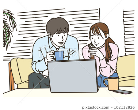 couple looking at computer on sofa 102132926