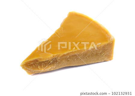 A piece of natural beeswax on a white background. A piece of natural beeswax on a white background. 102132931