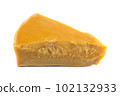 A piece of natural beeswax on a white background. 102132933