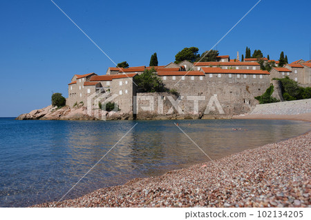 Beautiful empty beach near Sveti Stefan island at sunny summer day in Montenegro. Beautiful empty beach near Sveti Stefan island at sunny summer day in Montenegro. 102134205