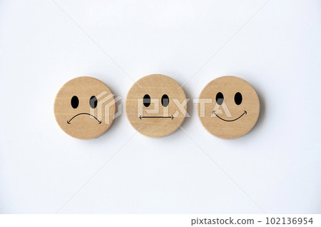 Happy, sad and neutral emoticon faces on wooden circle with white background cover. Customer feedback, satisfaction and evaluation and concept Happy, sad and neutral emoticon faces on wooden circle with white background cover. Customer feedback, satisfaction and evaluation and concept 102136954