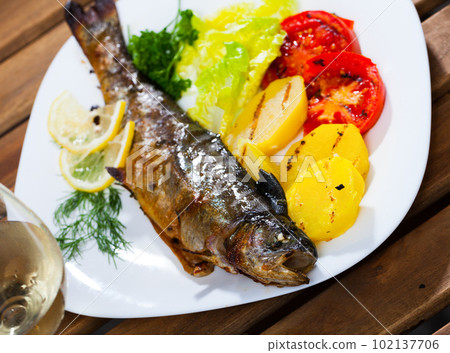 Baked trout with vegetables 102137706