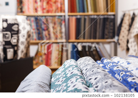 Fabric bolts on shop shelves 102138105