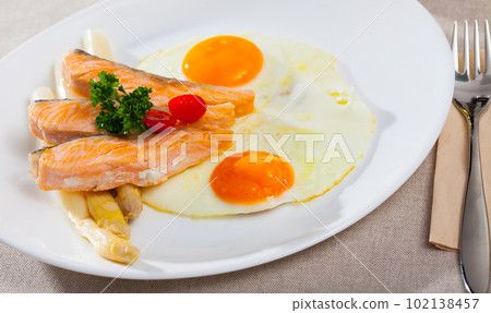 Fried salmon with scrambled eggs and asparagus Fried salmon with scrambled eggs and asparagus 102138457