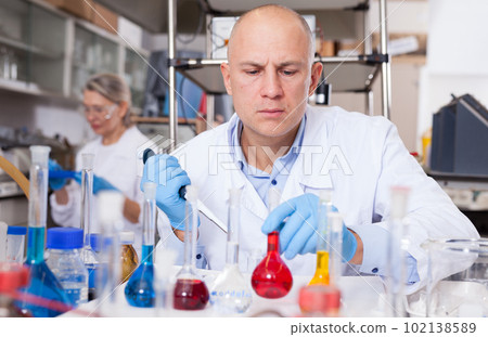 Chemist analyzing liquid samples Chemist analyzing liquid samples 102138589