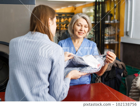 Woman receiving her clean menswear Woman receiving her clean menswear 102138756