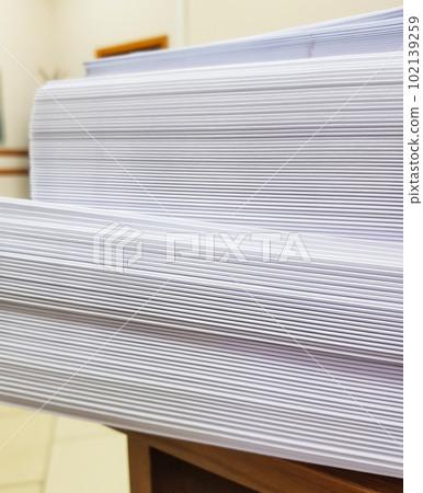 A stack of blank paper, book blocks prepared for binding in a printing house A stack of blank paper, book blocks prepared for binding in a printing house 102139259
