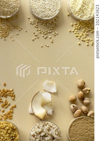 Mixed, gluten-free flour set on beige background with cereals, seeds and nuts Mixed, gluten-free flour set on beige background with cereals, seeds and nuts 102141623