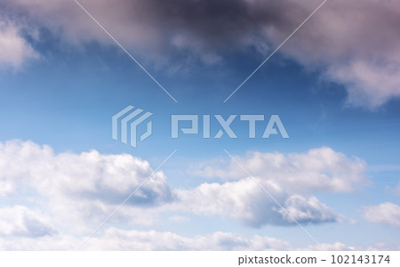 sunny weather forecast background. blue sky with white clouds above horizon in morning light 102143174