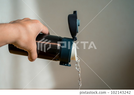 pour water from a water bottle pour water from a water bottle 102143242