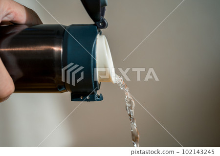 pour water from a water bottle pour water from a water bottle 102143245