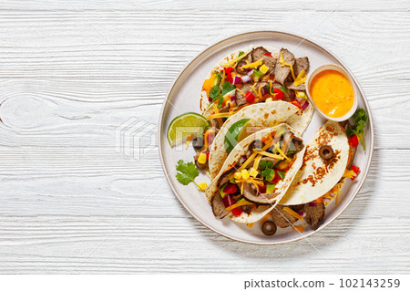 Beef Steak Tacos with veggies, avocado, corn 102143259