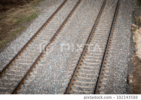 Two sets of railroad tracks run straight and parallel Two sets of railroad tracks run straight and parallel 102143588