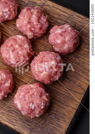 Raw meatballs of minced meat beef, pork or chicken with salt, spices and herbs Raw meatballs of minced meat beef, pork or chicken with salt, spices and herbs 102143609