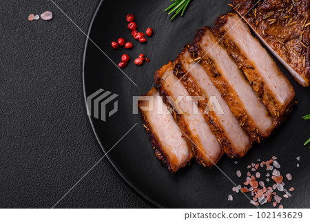 Delicious juicy pork steak on the bone with spices and herbs 102143629