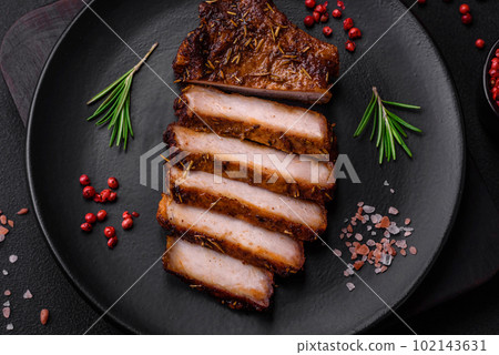 Delicious juicy pork steak on the bone with spices and herbs 102143631