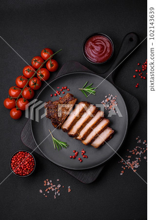 Delicious juicy pork steak on the bone with spices and herbs 102143639
