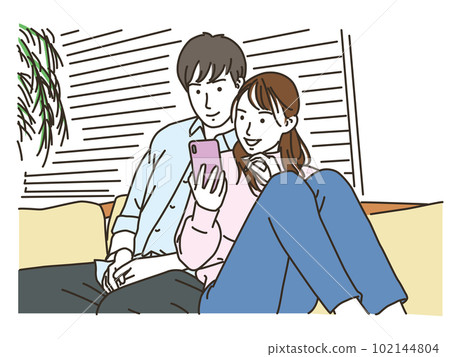 couple looking at smartphone on sofa 102144804