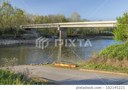 kayak on a boat ramp, Lamine River in early spring near Lamine, Missouri 102145221
