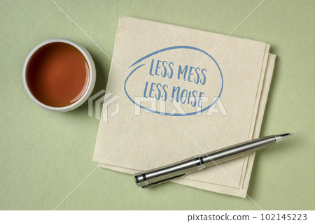 less mess, less noise - inspirational note on a napkin, decluttering, simplicity and minimalism concept 102145223