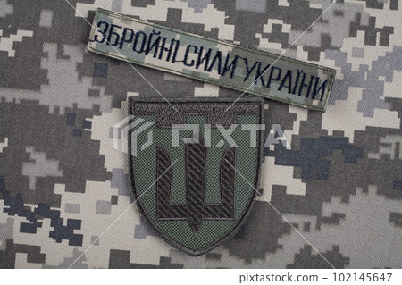 KYIV, UKRAINE - October 6, 2022. Russian invasion in Ukraine 2022. Territorial Defence Forces of Ukraine uniform insignia badge. Text in ukrainian - Armed Forces of Ukraine. KYIV, UKRAINE - October 6, 2022. Russian invasion in Ukraine 2022. Territorial Defence Forces of Ukraine uniform insignia badge. Text in ukrainian - Armed Forces of Ukraine. 102145647