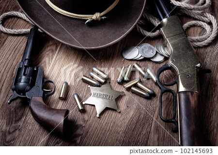 Old west rifle, revolver, ammunition and marshal badge with hat Old west rifle, revolver, ammunition and marshal badge with hat 102145693