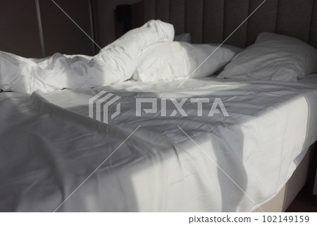 messy bed in early morning , messy bed after waking up  102149159