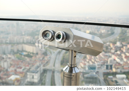 Coin-operated binoculars looking out over city , Coin-operated binoculars looking out over city , 102149415