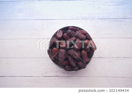 close up of fresh date fruit in a bowl on table  102149434