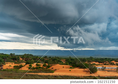 Solitary and Majestic Dunes, Plains, and Mountain Range under a Stormy Sky Solitary and Majestic Dunes, Plains, and Mountain Range under a Stormy Sky 102151150