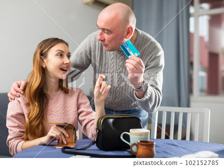 Husband giving plastic card to his wife 102152785