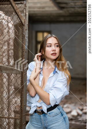 Desirable young woman posing in deserted building Desirable young woman posing in deserted building 102152786