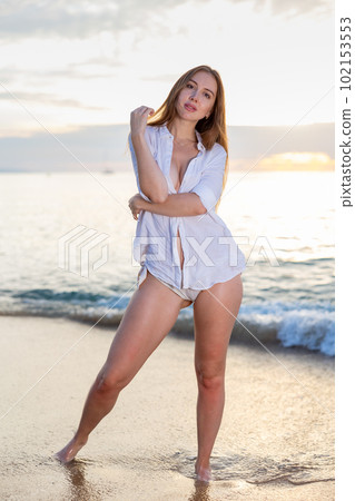 Portrait of sensual young lady enjoying warm, tropical ocean water 102153553