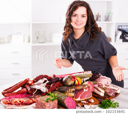 Woman stands with smoked products Woman stands with smoked products 102153691