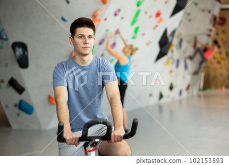 Sports guy on an exercise bike in climbing hall 102153893