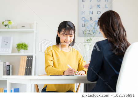 A young woman applying for membership at the office 102156691