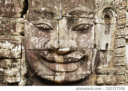 Face carved in stone in Angkor Wat Face carved in stone in Angkor Wat 102157308