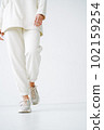 Crop photo of young woman in sportswear on background of white wall 102159254