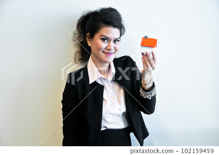 Business woman hold house toy model on white background Business woman hold house toy model on white background 102159459